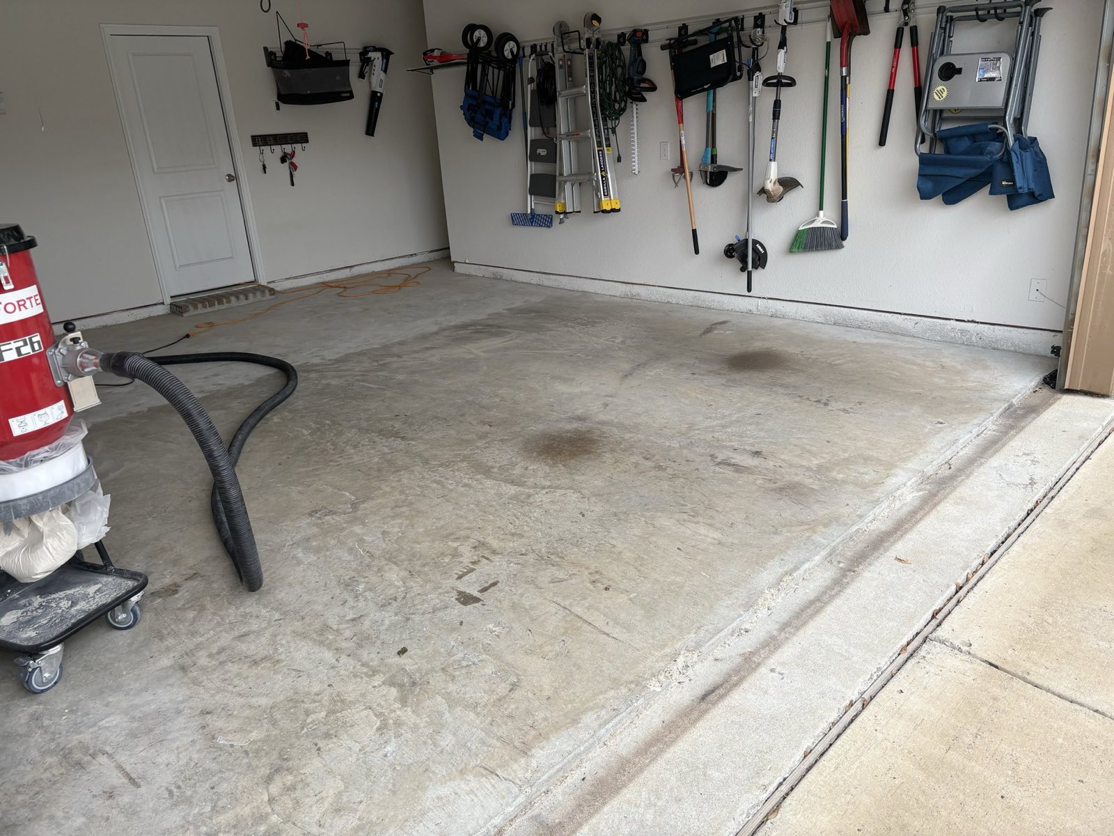 Before: bare concrete garage floor with oil stains in Wylie TX