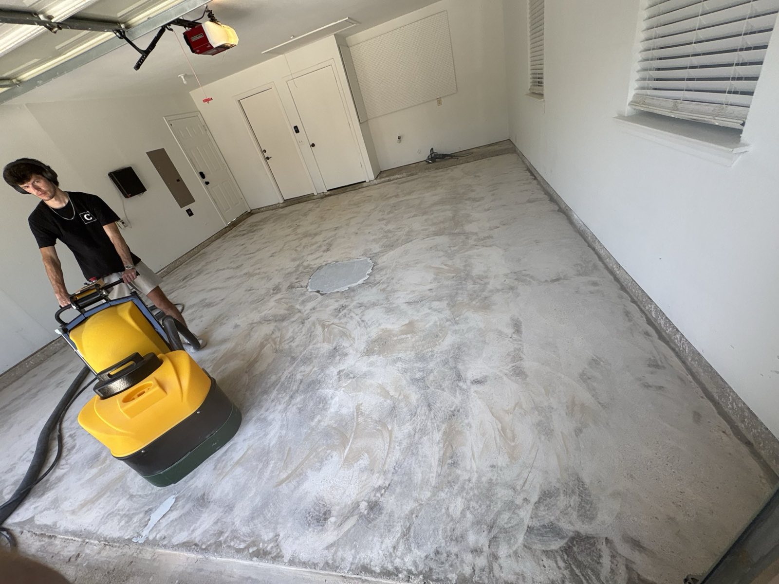 C3Epoxy diamond grinding a garage floor to prep concrete for epoxy, Lucas TX